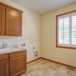 Large laundry room with cabinets & sink