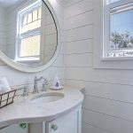 Powder room off kitchen with shiplap walls.