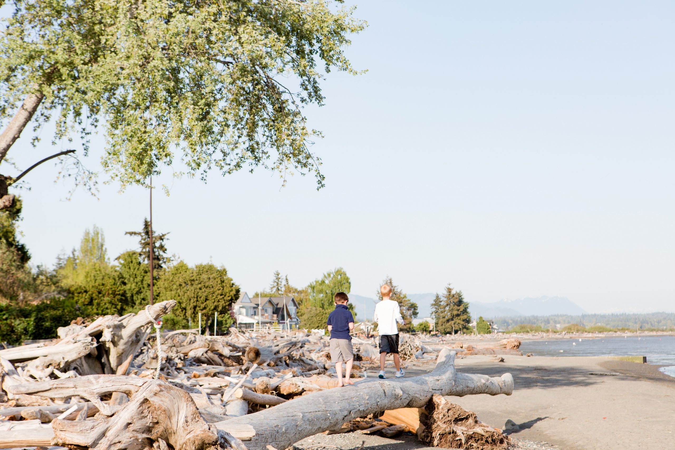 Boys walking on driftwood | Windermere Real Estate | Camano Island, WA