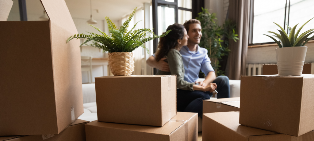 Couple sitting with moving boxes | Windermere Real Estate